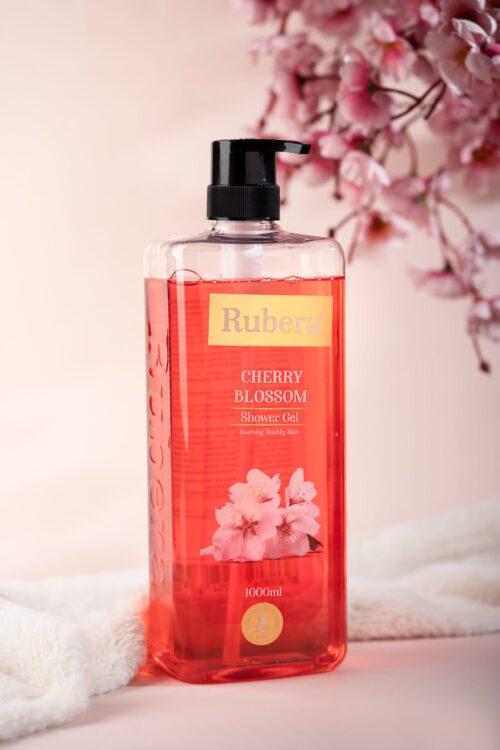 Rubera Cherry Blossom Shower Gel – 1000ml bottle with a floral cherry blossom-themed label, placed against a soft pink background with cherry blossoms in the frame.