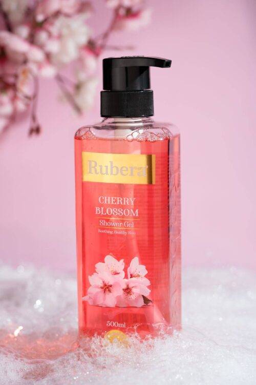 Rubera Cherry Blossom Shower Gel – 1000ml bottle with a floral cherry blossom-themed label, placed against a soft pink background with cherry blossoms in the frame.