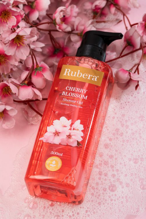 Rubera Cherry Blossom Shower Gel – 1000ml bottle with a floral cherry blossom-themed label, placed against a soft pink background with cherry blossoms in the frame.