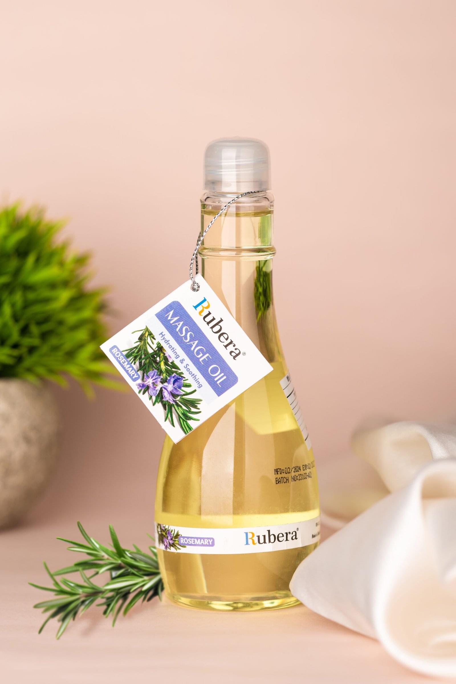Rosemary Massage Oil (125ml) 1 Rubera Rosemary Massage Oil – Hydrating and soothing massage oil in a transparent bottle with a silver cap, featuring a rosemary label and a hanging product tag.